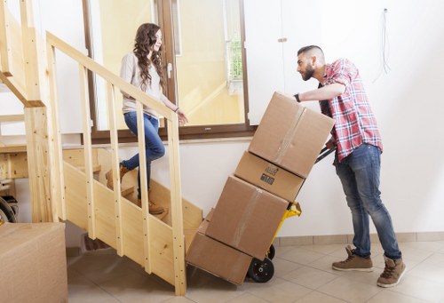 Professional removal team carrying furniture in Wapping